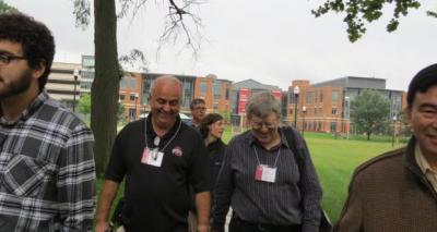 Faculty walking with the Union in the background