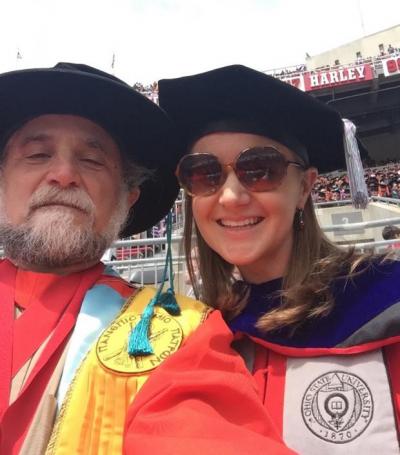 Grad student posing with professor at Graduation