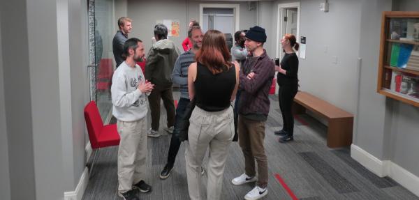 Students, faculty and staff have cocoa at the winter reception.