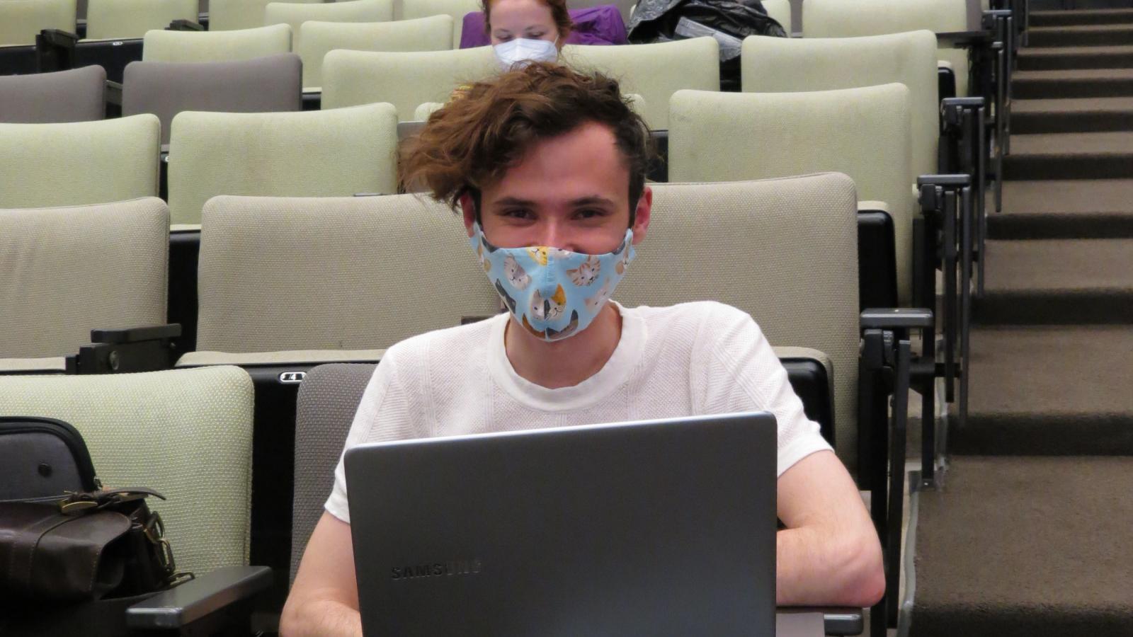 Picture of masked grad student in distanced classroom